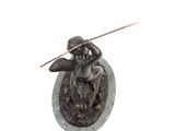 statue of an angel with a spear and shield on a stone base