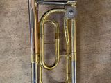 an image of a brass instrument laying on top of a carpeted floor