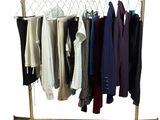 a rack with a variety of clothes hanging on it