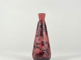 vase with a red and black floral design on a white background