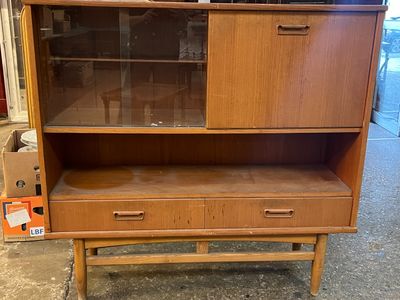 a wooden cabinet with a glass door on top of it