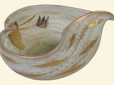 a glass bowl with a gold decoration on it