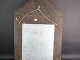an old wooden mirror with a rope hanging from it ' s side