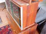 a fish tank sitting on top of a wooden stand