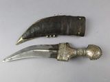 two pieces of silverware and a knife on a white surface