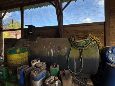 a large tank of gas sitting next to other containers
