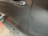 a close up of a car door handle with a sticker on it