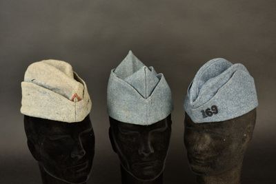 three hats are lined up on a mannequin head