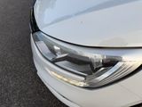a close up of a car ' s headlight on the street
