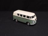 a toy bus that is sitting on a black surface
