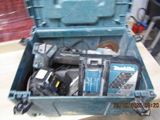 a blue tool box with tools in it on a table