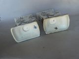 two white dishes sitting on a table next to each other