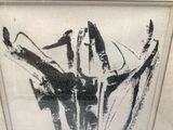 a black and white picture of a vase with flowers in it