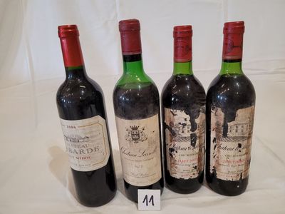 four bottles of wine are lined up on a table