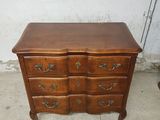 a wooden dresser with many drawers on top of it