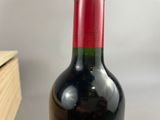 a bottle of wine sitting on a table next to a box