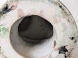 a white vase that has a hole in the middle of it