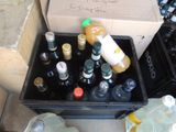 many bottles of beer in a box on the ground