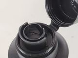 a black bottle with a black lid and a black cap