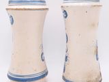 two blue and white vases on a white surface