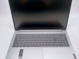 the laptop is open on a white surface with a black screen