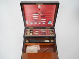 a wooden box with various items in it on a table