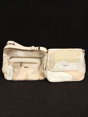two pieces of luggage that are sitting on a black surface