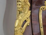 a wooden cabinet with a gold decoration on it