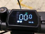 a digital clock on the handlebar of a bike