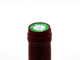 a bottle of wine that has a green label on it