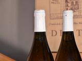 three bottles of wine that are sitting on a table