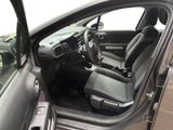 the interior of a car with the door open and the driver ' s seat down