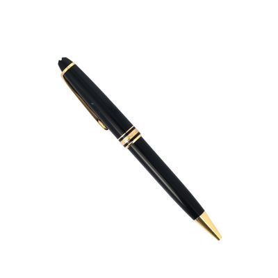 a black and gold pen sitting on top of a white surface