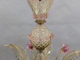 a glass chandelier with a bird perched on top of it