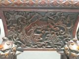 a close up of a wooden table with carvings on it
