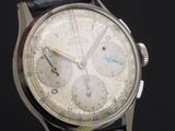 an image of a close up of a wrist watch on a black surface