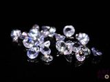 a close up of a bunch of diamonds on a black surface