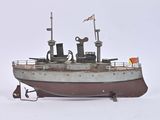 a small model of a boat on a white surface
