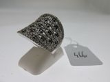 silver ring with black and white diamonds on a white surface
