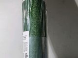 a roll of green grass that is wrapped in plastic