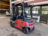 a red fork truck parked in front of a building