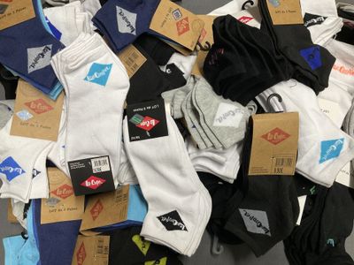 many pairs of socks that are on the floor