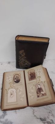 an open book sitting on a table next to a book with pictures on it