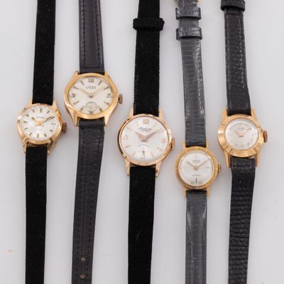 four different types of watches are lined up on a white surface