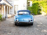 a blue car that is parked in front of a house