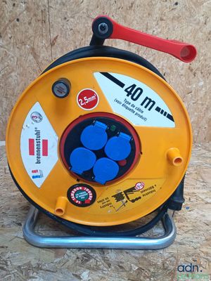 a yellow reel with blue buttons on it on a stand