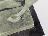 a statue of a bird that is sitting on top of a book