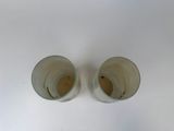 two empty cups sitting on a white surface