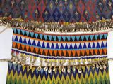 a multicolored belt with a cowrie on it