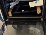 a black oven with a glass door and a rack in it